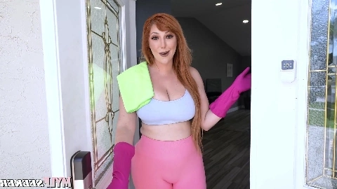 A fiery-haired woman possessing exceptionally full breasts and a considerable rear.